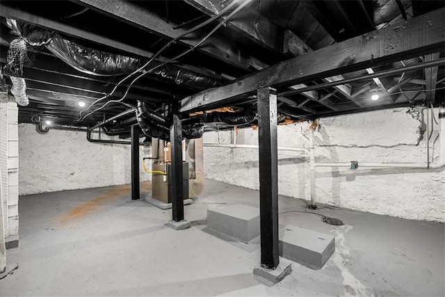 unfinished below grade area featuring heating unit