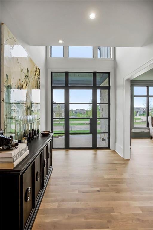 entryway featuring recessed lighting, baseboards, and light wood-type flooring