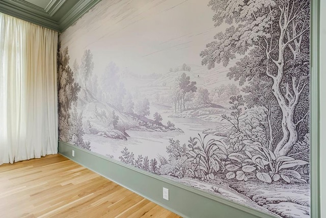 unfurnished room featuring crown molding, baseboards, and wood finished floors