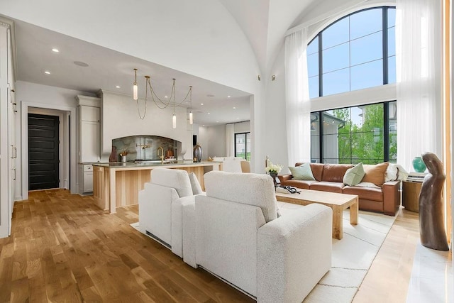 living area with recessed lighting, plenty of natural light, and light wood-style floors