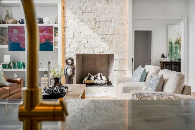 living room with a stone fireplace
