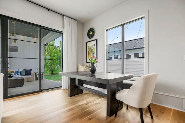 dining area featuring light wood-style flooring