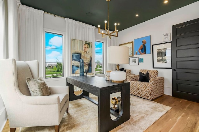 office with recessed lighting, an inviting chandelier, and wood finished floors