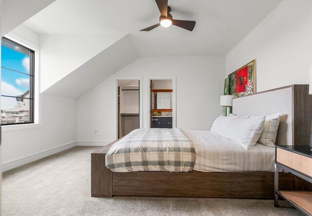 bedroom with baseboards, carpet flooring, ceiling fan, and vaulted ceiling