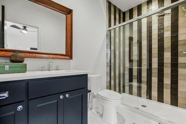 bathroom with vanity, a stall shower, and toilet