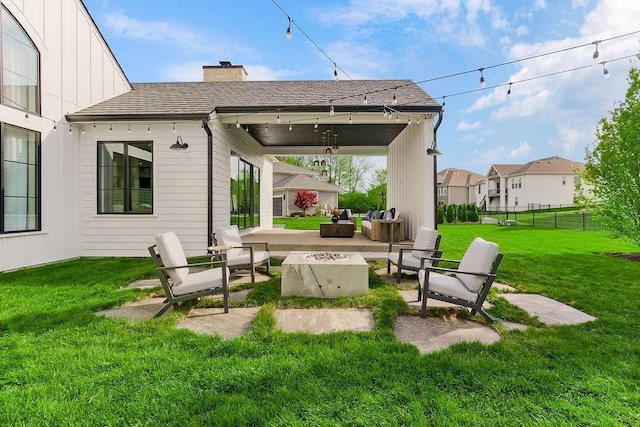 view of patio featuring fence and an outdoor living space with a fire pit