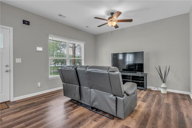 living room with visible vents, ceiling fan, dark wood-style flooring, and baseboards