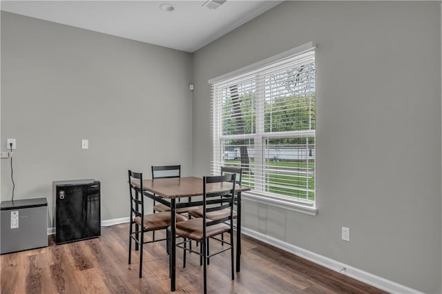 dining room featuring wood finished floors and baseboards