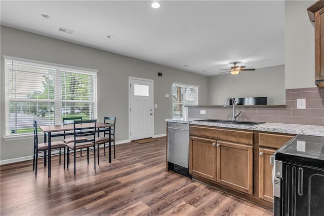 kitchen with stainless steel dishwasher, a sink, visible vents, a ceiling fan, and a peninsula