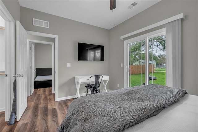 bedroom featuring access to exterior, visible vents, wood finished floors, and baseboards