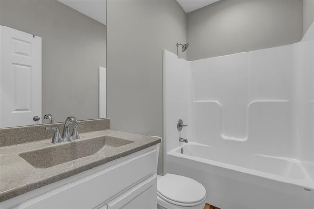 bathroom featuring toilet, bathing tub / shower combination, and vanity
