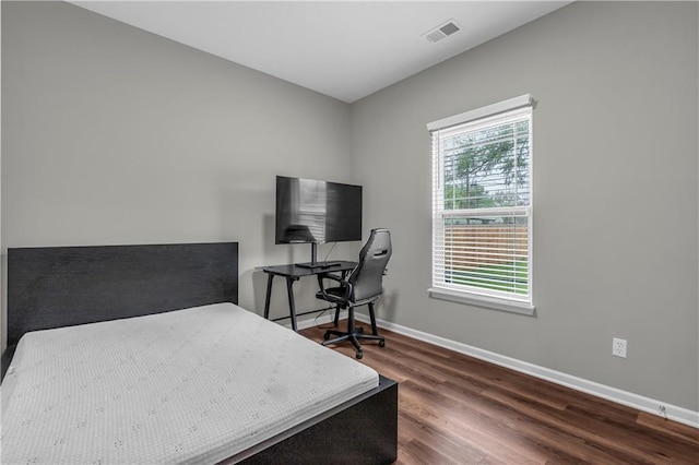 office space with visible vents, wood finished floors, and baseboards