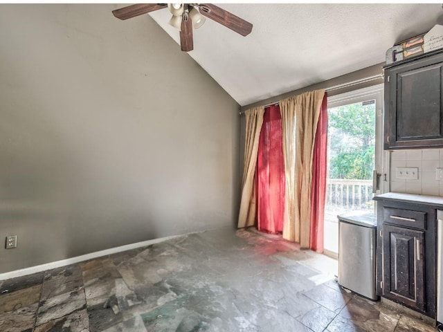 1904 NW Harbor Pl, Blue Springs, MO 64015 - unfurnished dining area featuring a ceiling fan, vaulted ceiling, and stone finish flooring