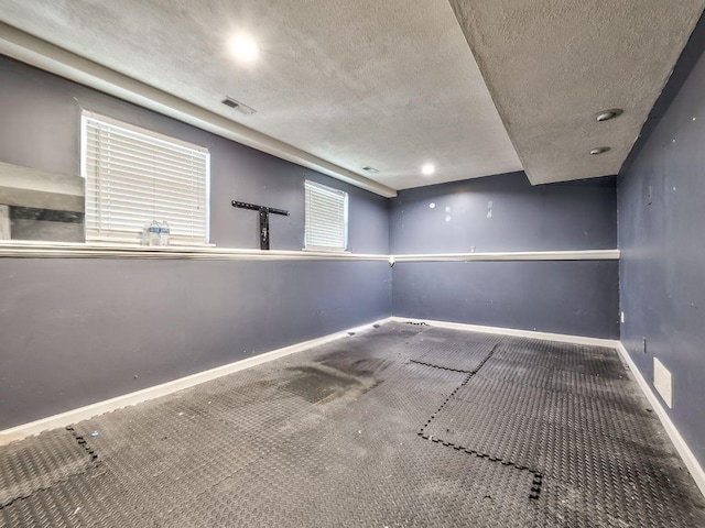 1904 NW Harbor Pl, Blue Springs, MO 64015 - spare room with a textured ceiling, carpet floors, and baseboards