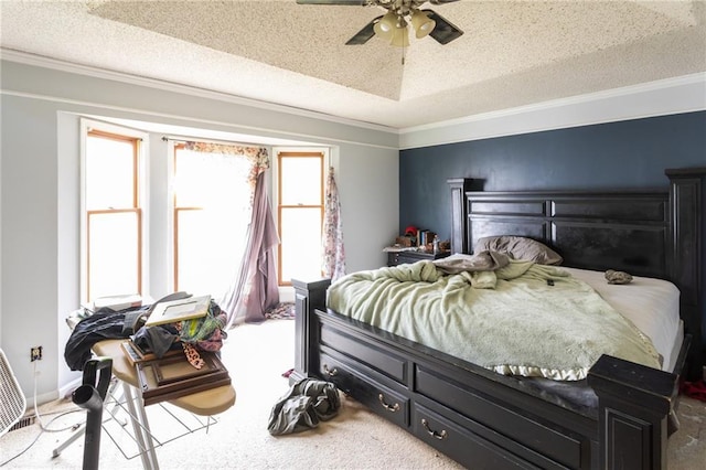 carpeted bedroom featuring a textured ceiling, crown molding, and a ceiling fan