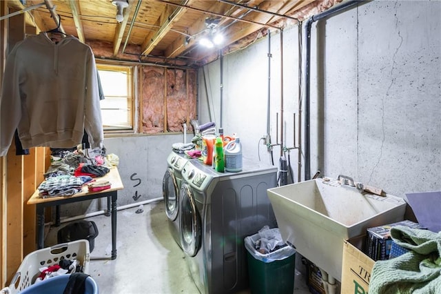 washroom featuring washing machine and dryer and a sink