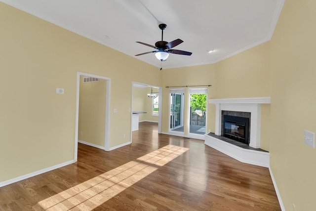 unfurnished living room featuring visible vents, crown molding, a fireplace, baseboards, and ceiling fan with notable chandelier