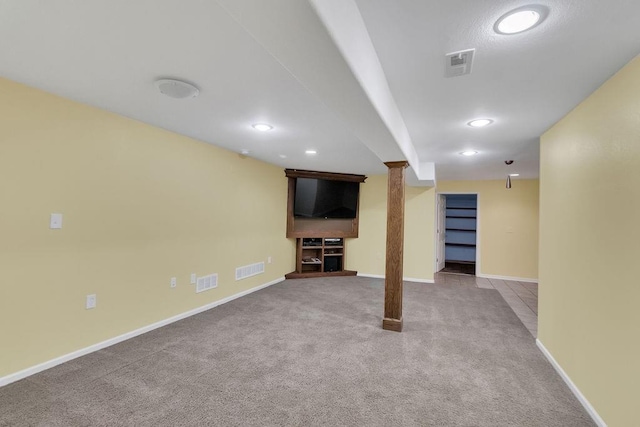 finished basement with baseboards, carpet flooring, and visible vents