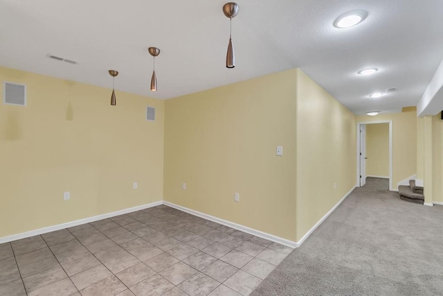 spare room with stairs, baseboards, and visible vents