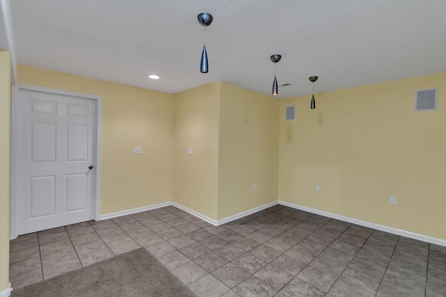 tiled spare room with recessed lighting, baseboards, and visible vents