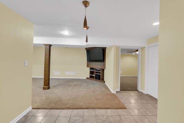 basement featuring visible vents, light tile patterned floors, baseboards, light carpet, and recessed lighting