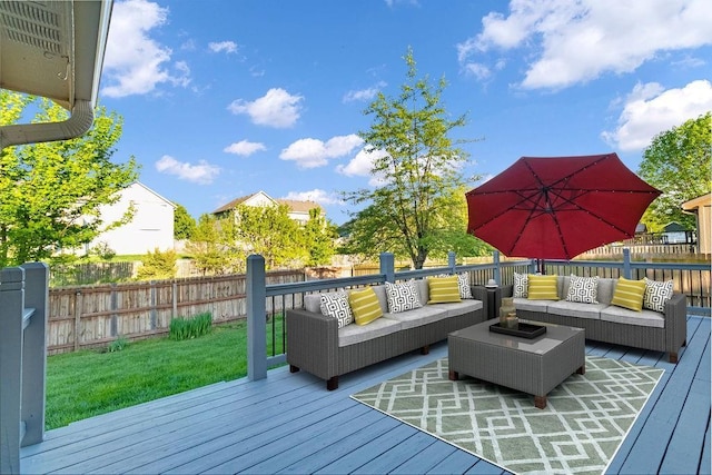 wooden deck with an outdoor living space and a fenced backyard