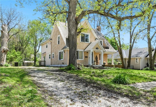 314 N Lake St, Pleasant Hill, MO 64080 - view of front of house featuring cooling unit, stucco siding, a chimney, and a front yard