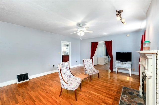 314 N Lake St, Pleasant Hill, MO 64080 - sitting room featuring baseboards, a ceiling fan, wood finished floors, and visible vents