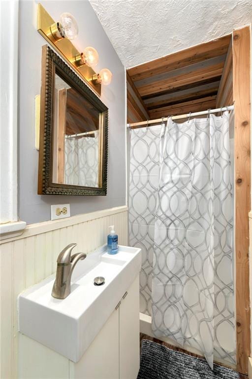314 N Lake St, Pleasant Hill, MO 64080 - bathroom featuring vanity, a textured ceiling, a wainscoted wall, and curtained shower