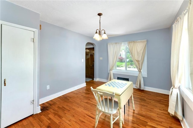 314 N Lake St, Pleasant Hill, MO 64080 - dining space with arched walkways, baseboards, and wood finished floors