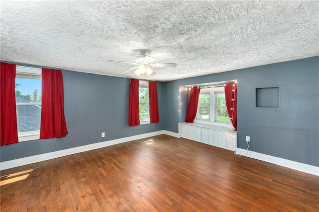 314 N Lake St, Pleasant Hill, MO 64080 - unfurnished room with baseboards, a textured ceiling, ceiling fan, and wood finished floors