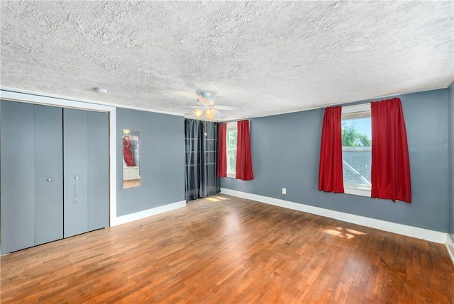 314 N Lake St, Pleasant Hill, MO 64080 - unfurnished bedroom featuring baseboards, a textured ceiling, and wood finished floors