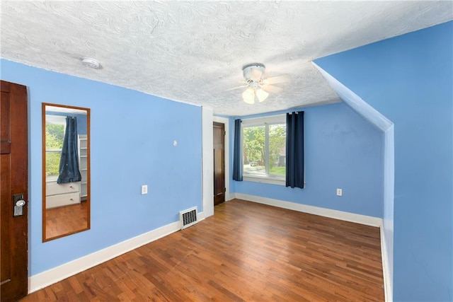 314 N Lake St, Pleasant Hill, MO 64080 - bonus room featuring ceiling fan, a textured ceiling, baseboards, wood finished floors, and visible vents