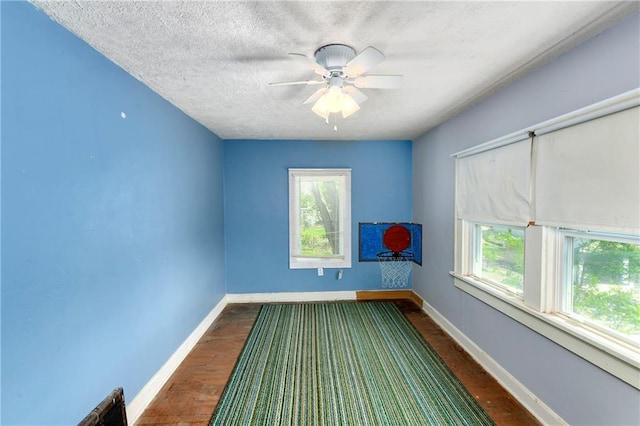 314 N Lake St, Pleasant Hill, MO 64080 - unfurnished room featuring a ceiling fan, dark wood-type flooring, and a wealth of natural light