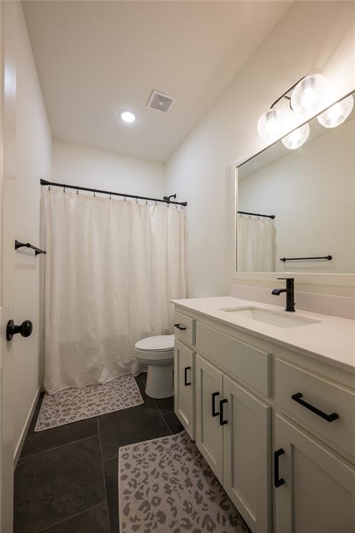 bathroom featuring vanity, toilet, tile patterned floors, recessed lighting, and curtained shower