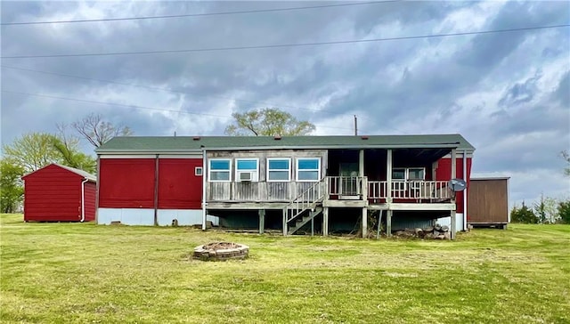 15823 Colorado Pl, Princeton, MO 64673 - rear view of house with an outdoor fire pit, a yard, and a deck