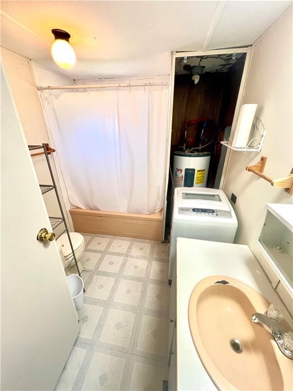 15823 Colorado Pl, Princeton, MO 64673 - bathroom with electric water heater, vanity, shower / tub combo, and tile patterned floors