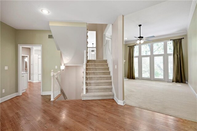 staircase featuring baseboards, a ceiling fan, recessed lighting, wood finished floors, and crown molding