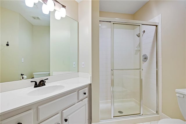 full bathroom with toilet, a shower stall, and vanity