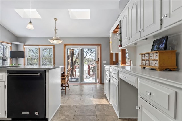 6732 Clairborne Rd, Shawnee, KS 66217 - kitchen with black dishwasher, a skylight, white cabinets, light countertops, and pendant lighting