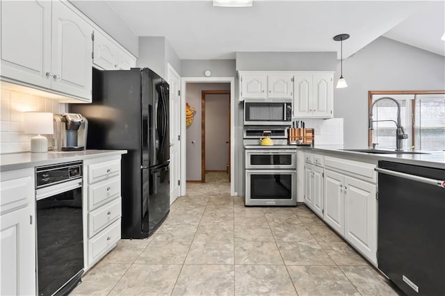 6732 Clairborne Rd, Shawnee, KS 66217 - kitchen with black appliances, tasteful backsplash, a sink, white cabinets, and vaulted ceiling