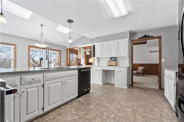 6732 Clairborne Rd, Shawnee, KS 66217 - kitchen with a skylight, black dishwasher, vaulted ceiling, white cabinets, and a sink
