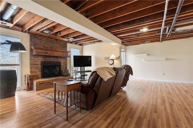 6732 Clairborne Rd, Shawnee, KS 66217 - living room featuring a brick fireplace, wood finished floors, and baseboards