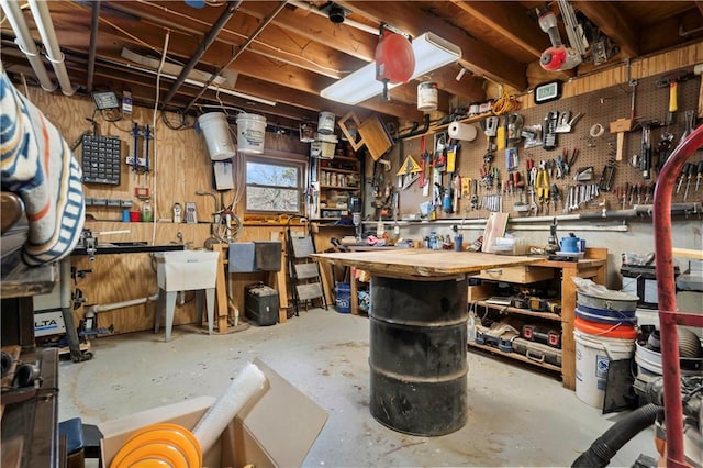 6732 Clairborne Rd, Shawnee, KS 66217 - miscellaneous room featuring a workshop area and unfinished concrete flooring