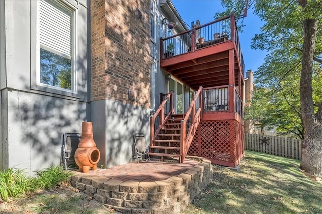 6732 Clairborne Rd, Shawnee, KS 66217 - rear view of house with brick siding, stairs, and a wooden deck