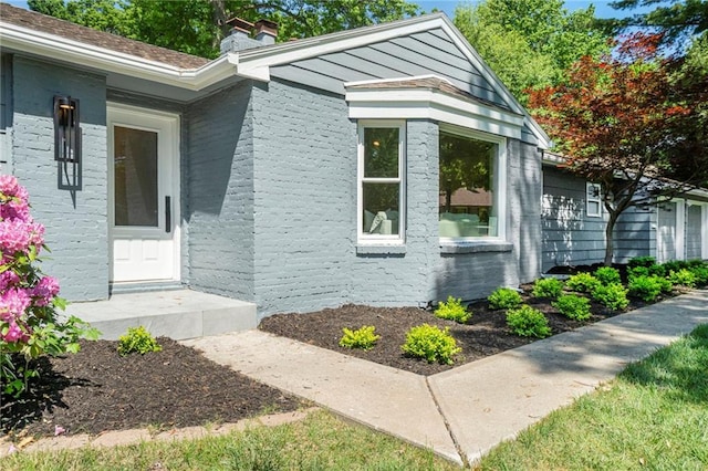 9440 Manor Rd, Leawood, KS 66206 - doorway to property with a chimney and brick siding