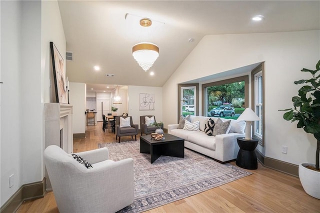 9440 Manor Rd, Leawood, KS 66206 - living room with wood finished floors, high vaulted ceiling, and recessed lighting