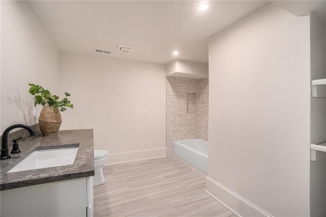 9440 Manor Rd, Leawood, KS 66206 - full bath with baseboards, vanity, toilet, recessed lighting, and washtub / shower combination