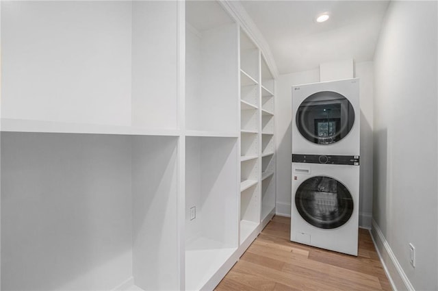 9440 Manor Rd, Leawood, KS 66206 - laundry room featuring estacked washer and dryer, wood finished floors, and baseboards