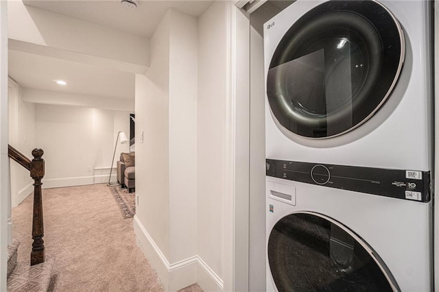 9440 Manor Rd, Leawood, KS 66206 - laundry area featuring stacked washer / dryer, carpet floors, and baseboards